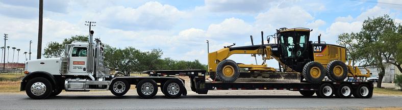 Diamond Eight lowboy hauling CAT motor grader — South Texas